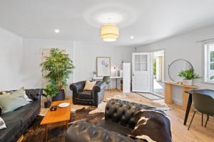 a living room with a couch and a table at Kowhai Apartment-Ground Floor in Pukekohe East