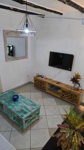 a living room with a flat screen tv on the wall at Villa Tewa in Mtwapa