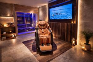 a stroller in a room with a flat screen tv at ExSPArience Private Spa Suite in Poitiers