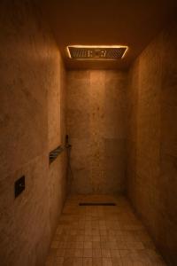 an empty room with a tile floor and a ceiling at ExSPArience Private Spa Suite in Poitiers