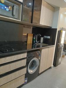 a kitchen with a sink and a washing machine at scandic resort sea view balcony free wi fi in Hurghada
