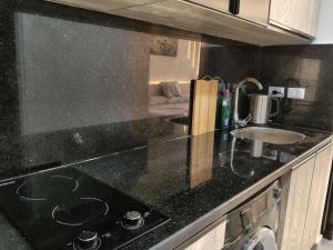 a kitchen with a black counter top and a sink at scandic resort sea view balcony free wi fi in Hurghada