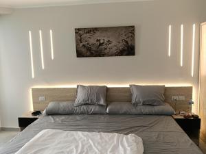 a bedroom with a bed with a painting on the wall at scandic resort sea view balcony free wi fi in Hurghada +54 photos