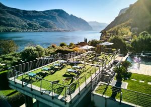 a resort with a view of a lake and mountains at Bellagio Village - Holiday Apartments by the Lake - Seasonal Warm Pool and Sauna in Oliveto Lario +64 photos