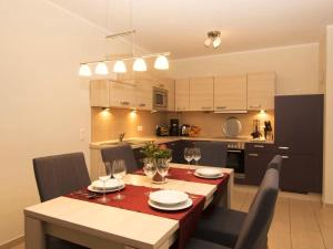 a kitchen and dining room with a table and chairs at Casa Cavallo in Göhren-Lebbin
