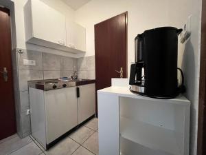 a small kitchen with a coffee maker on a counter at Mariazellerhof Room 014 in Sankt Pölten