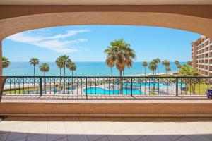 a view of the beach from the balcony of a resort at 3 Bedroom Beach Front at Sonoran Spa E410 in Puerto Peñasco