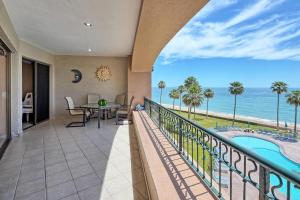 a balcony with a table and a view of the ocean at 3 Bedroom Beach Front at Sonoran Spa E410 in Puerto Peñasco +30 photos