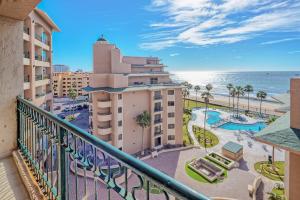 a balcony with a view of the ocean and a resort at Oceanfront hideaway at Sonoran Spa N608 in Puerto Peñasco