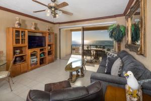 a living room with a couch and a tv at Oceanfront hideaway at Sonoran Spa N608 in Puerto Peñasco +24 photos