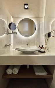 a bathroom with a sink and a mirror at Casa los Cantaros Hotel Boutique in Oaxaca City +52 photos