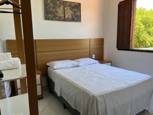 a small bedroom with a bed and a window at Casa - Conceito in Bom Jesus da Lapa