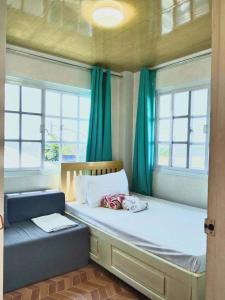 a bedroom with a large bed and two windows at Rustic Retreat room only in San Fernando
