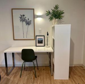 a white desk with a chair and a plant at Kowhai Apartment-Ground Floor in Pukekohe East +5 photos