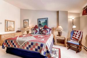 a bedroom with a bed and a chair at Seasons at Avon, A Vail Resorts Property in Avon +84 photos