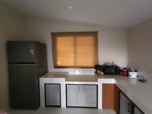 a kitchen with a black refrigerator and a window at Koh tao two view in Ko Tao