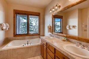 a bathroom with two sinks and a tub and a large mirror at Crested Butte Mountain Resort Properties by Vail Resorts in Crested Butte +186 photos