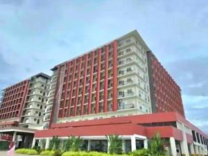 a large red and white building at Primeworld District with Balcony near Mactan Airport in Pajak