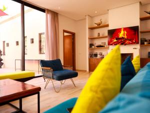 a living room with a couch and a tv at Villa des iris Domaines NAJMA in Marrakesh