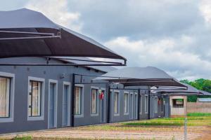 a row of umbrellas in front of a building at Alikho luxury accommodation in Abisai