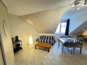 a living room with a couch and a table at Appartement centre Compiègne in Compiègne