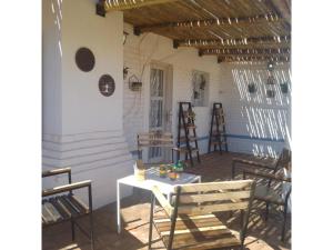 a patio with chairs and a table and a table at Casa Willy Pampa in Barreal