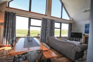 a living room with a table and a couch at Corncrake Cottage in Leverburgh