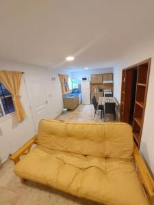 a living room with a yellow couch in a room at Flor del Aromito in Alta Gracia +9 photos