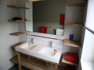 a bathroom with a white sink and a mirror at Countryside holiday home in Gijverinkhove +18 photos
