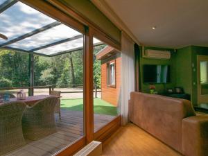 a screened in porch with a table and chairs at Villa Maashorst in Uden