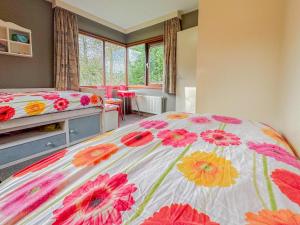 a bedroom with a bed with flowers on it at Villa Maashorst in Uden