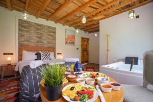 a room with a bed and a table with food on it at Riad Atlas Bangalow in Imlil