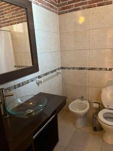 a bathroom with a sink and a toilet at Complejo Laderas del Cerro in Piriápolis +88 photos