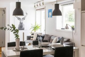 a living room with a table and a couch at Central 4 room apartment in Bergen