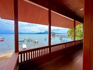 a room with a view of the water and boats at MC Bunaken Stay Diving Trip's in Bunaken