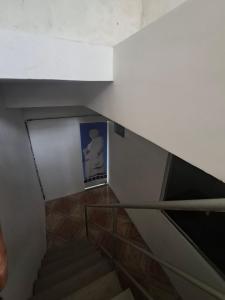 a stair case with a picture of a man on the wall at Bem no Centro in Juazeiro do Norte