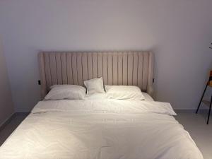 a large white bed with two pillows on it at فنادق مخدومة in Quai