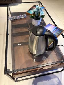 a tea kettle sitting on a glass table at فنادق مخدومة in Quai +1 photo