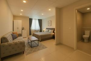 a hotel room with a bed and a couch and a chair at Nera Otel in Istanbul