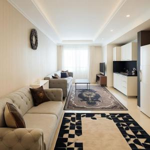 a living room with a couch and a kitchen at Nera Otel in Istanbul
