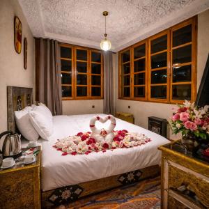 a bedroom with a bed with a stuffed animal on it at Riad dreams imlil in Imlil