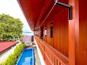 a building with a swimming pool on the side of it at MC Bunaken Stay Diving Trip's in Bunaken