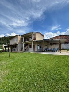 a large building with a lawn in front of it at Pousada Sol e Mar Dias Cezar in Paraty