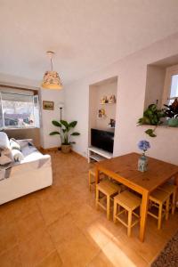 a living room with a table and a couch at Sintra Central Apartment in Sintra