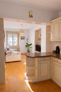 a kitchen with a counter and a living room at Sintra Central Apartment in Sintra