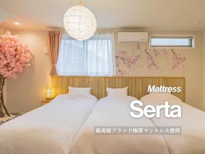 a bedroom with two beds and a window at suite Funabashi SAKURA1 #102 in Funabashi +48 photos