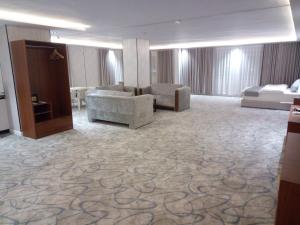 a large room with couches and chairs in a building at ﻣﺆﺳﺴﺔ ﺷﻘﻖ ﺍﻟﻘﺎﺭﺍﺕ ﺍﻟﺴﺒﻊ ﺍﻟﻤﺨﺪﻭﻣﺔ in Raḩīmah