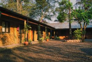 a brick building with plants in front of it at Piedra Alta Hotel & Restaurante in Itá Ibaté