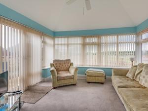 a living room with a couch and a chair at The Saddlery - Uk36123 in Horsington