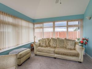 a living room with a couch and some windows at The Saddlery - Uk36123 in Horsington